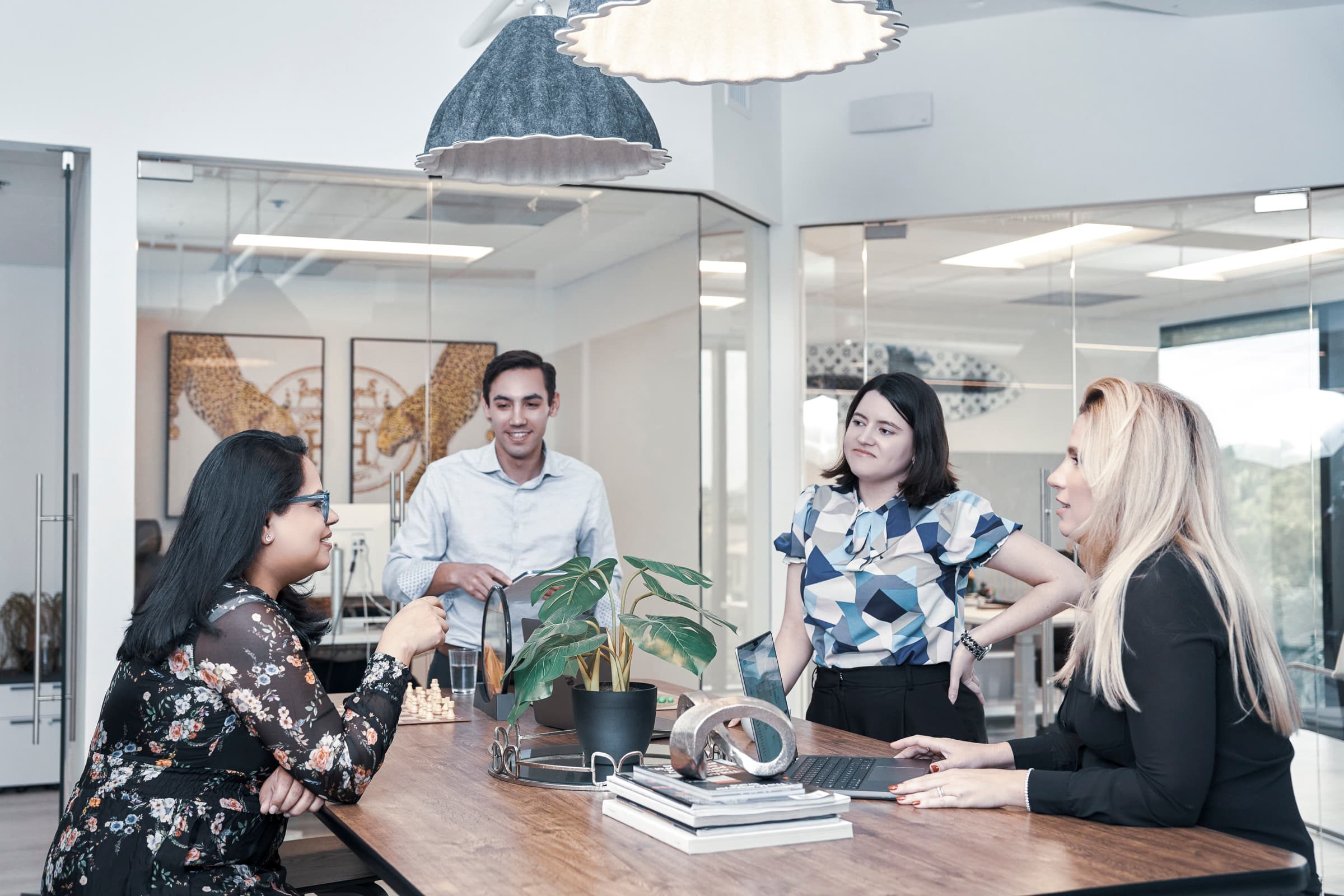 Coworkers chatting in the office, demonstrating thoughtful composition