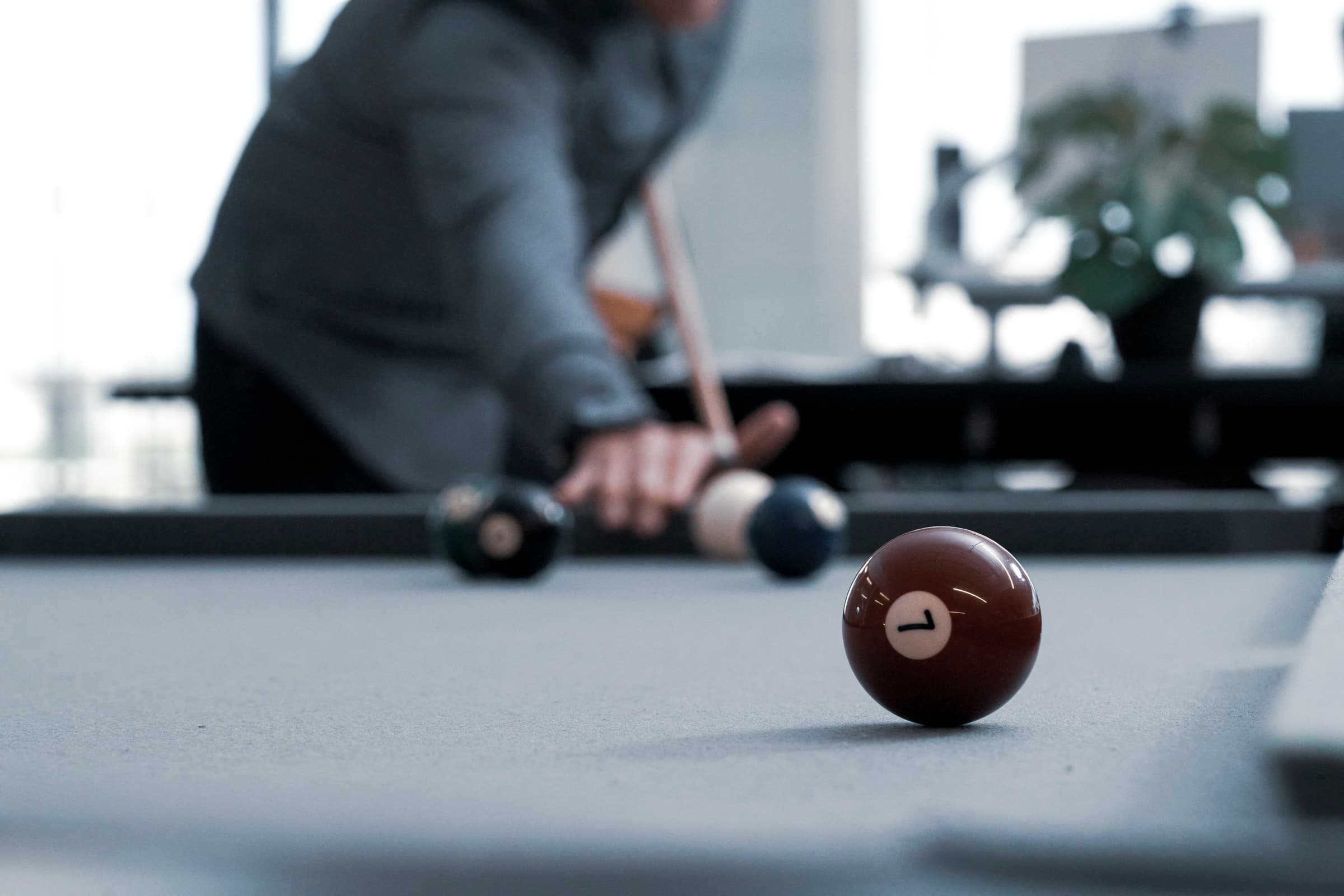 Man playing pool in the office recreation area