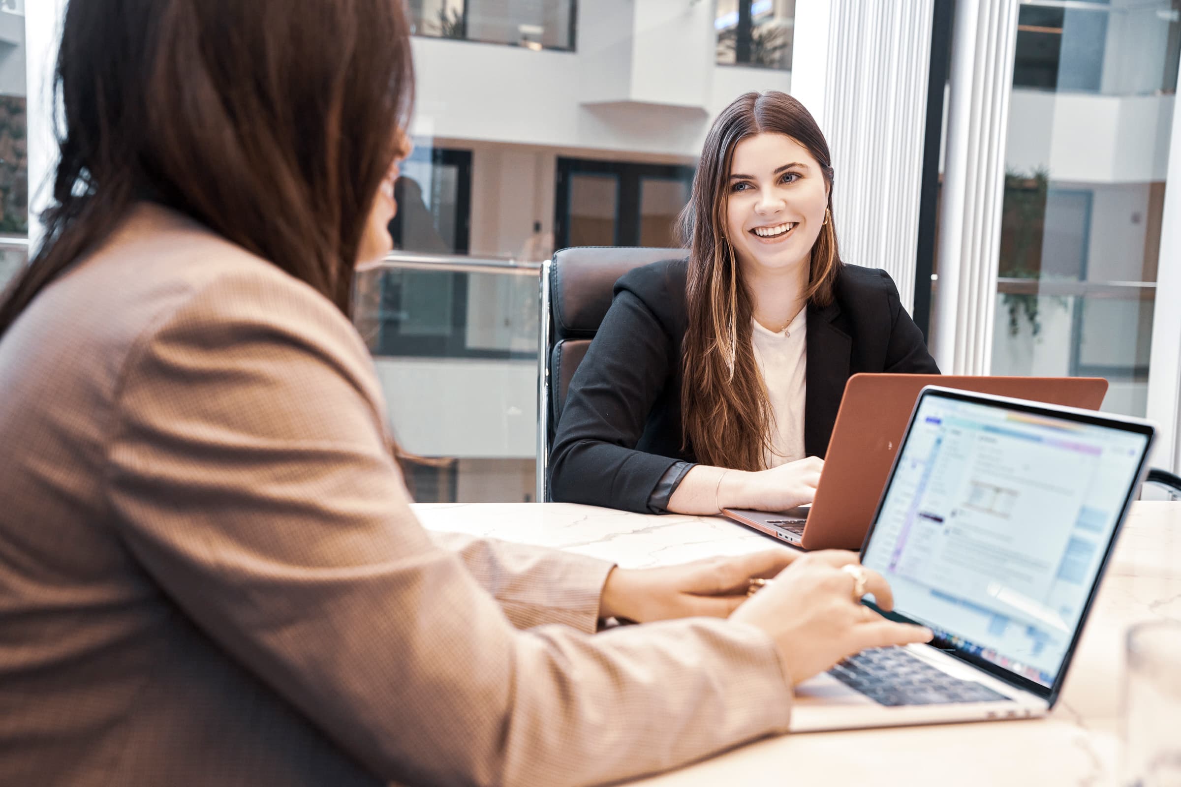 Two women collaborating in an office meeting