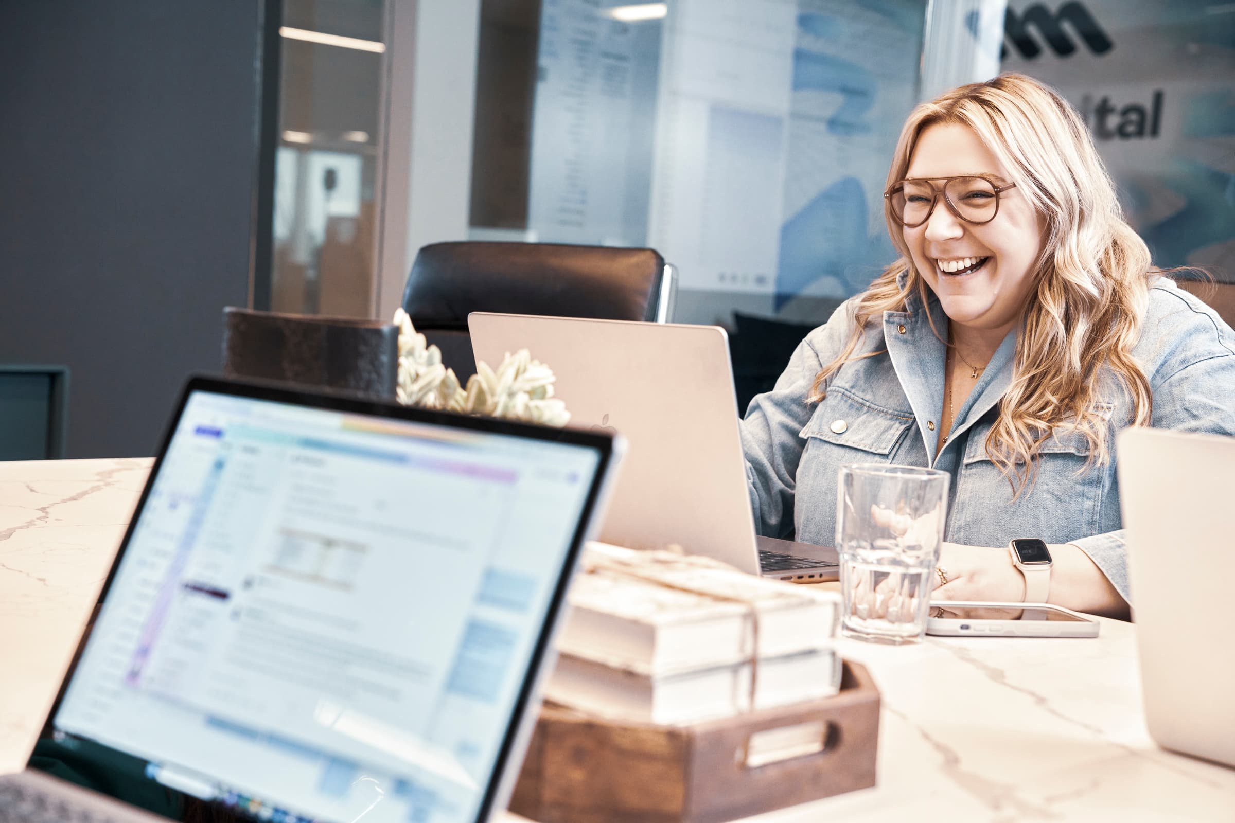 Woman laughing candidly at her desk