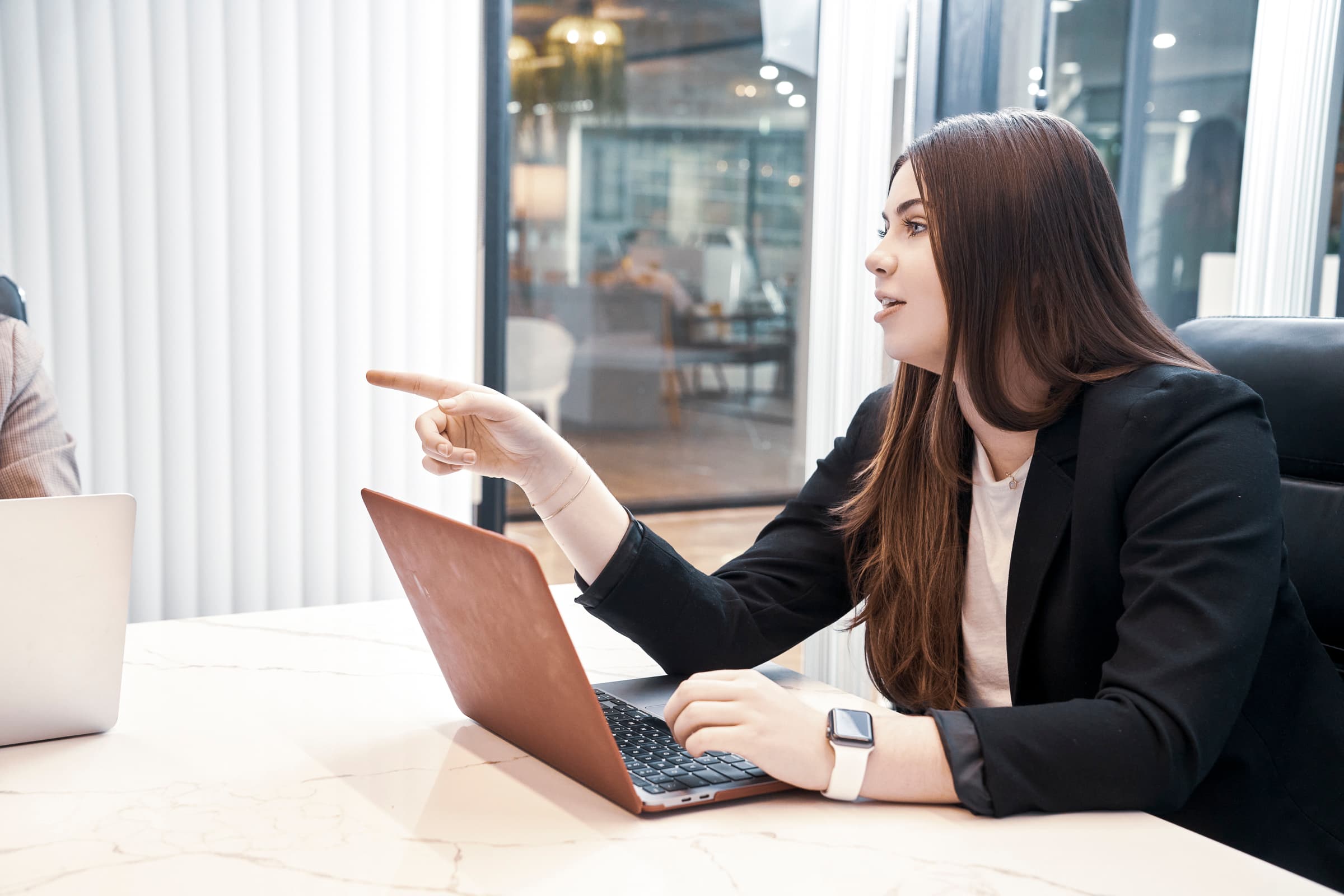 Woman pointing and directing conversation during a meeting