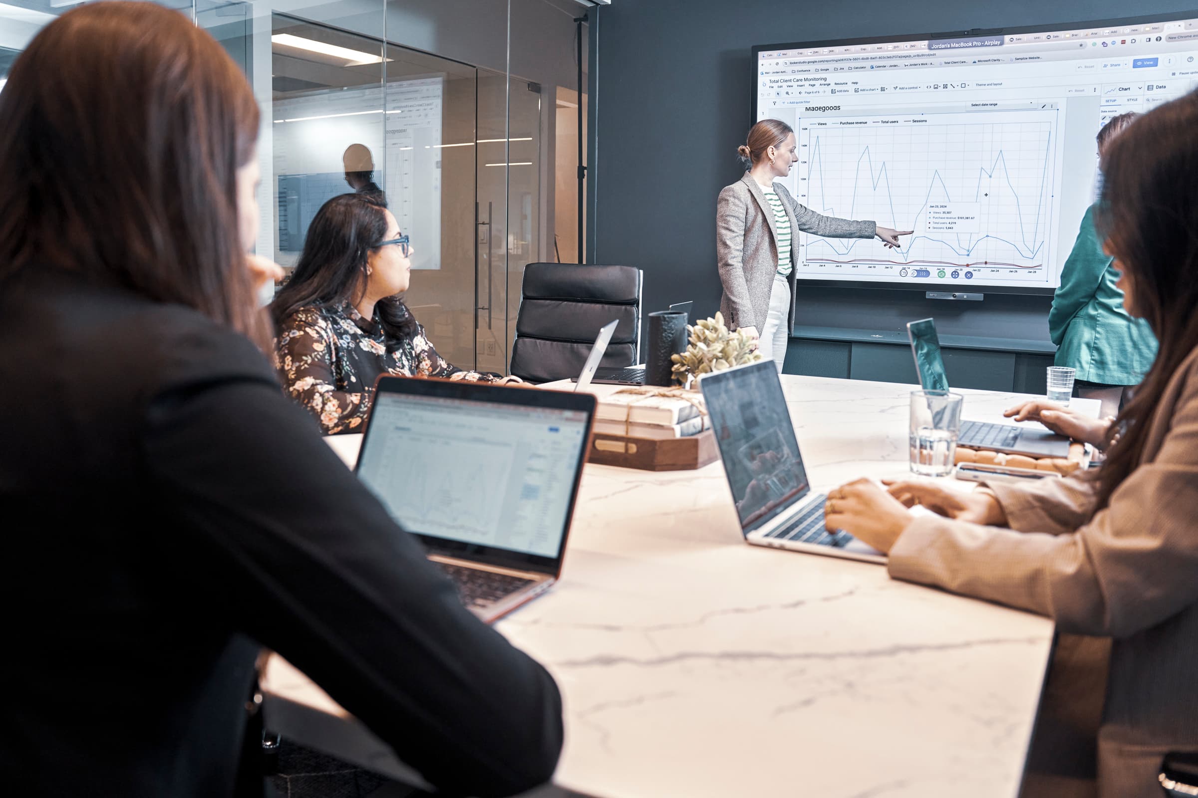 Woman presenting data charts during a team meeting