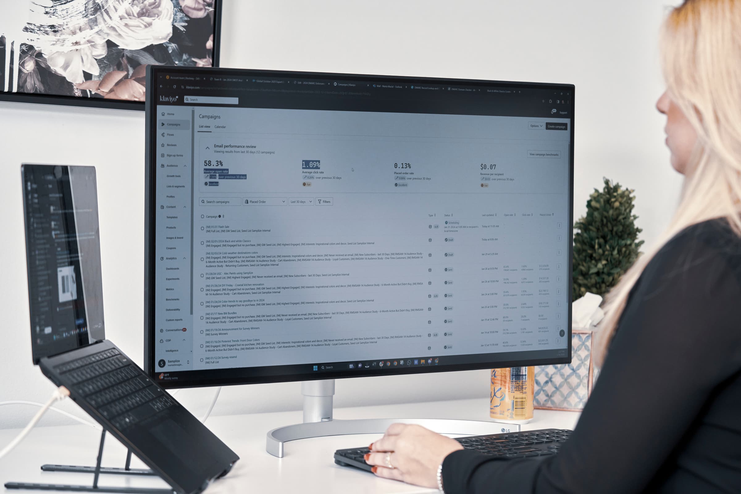 Woman reviewing email campaigns in soft natural light